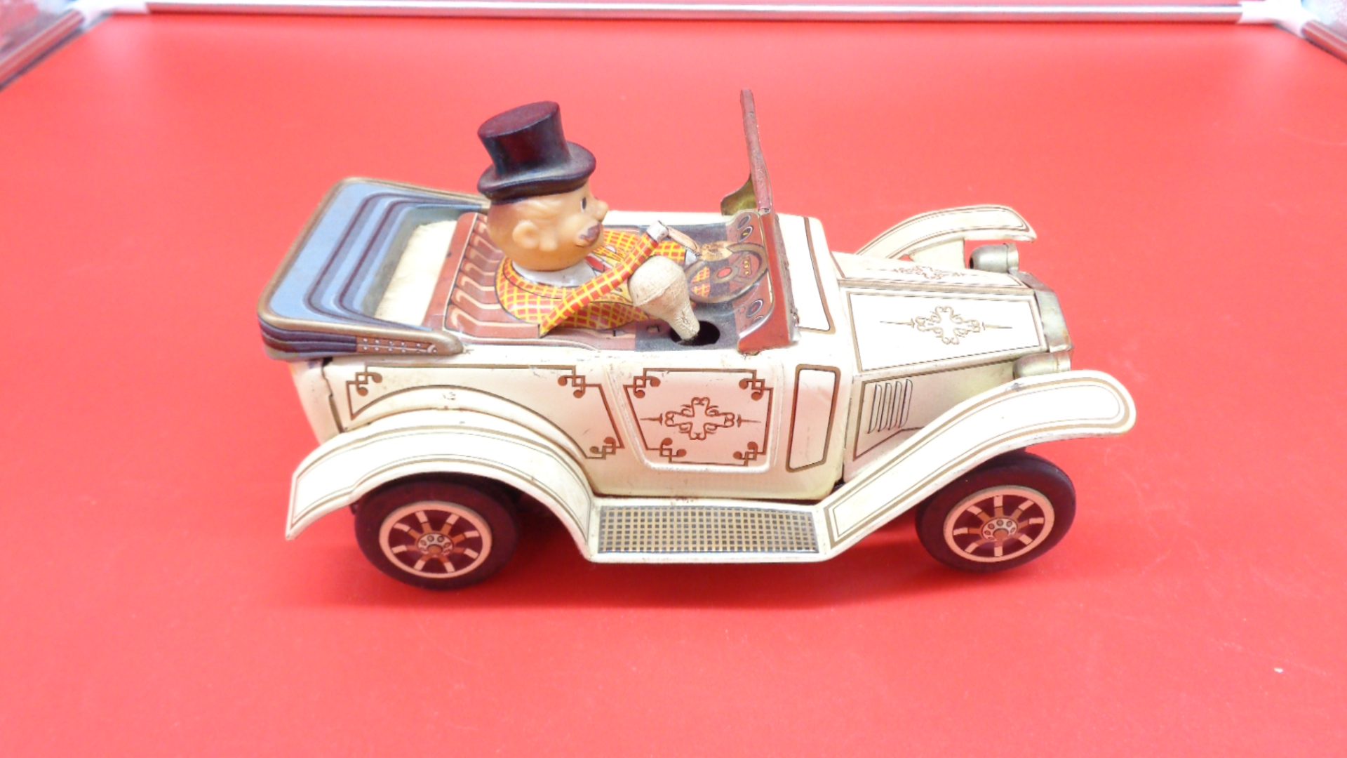 Vintage toy luxury car with a man