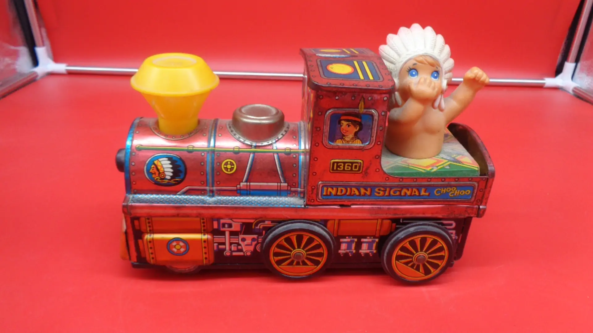 Small vintage toy train with a baby native American on the back