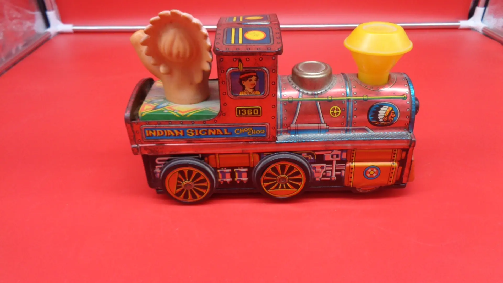 Small vintage toy train with a baby native American on the back