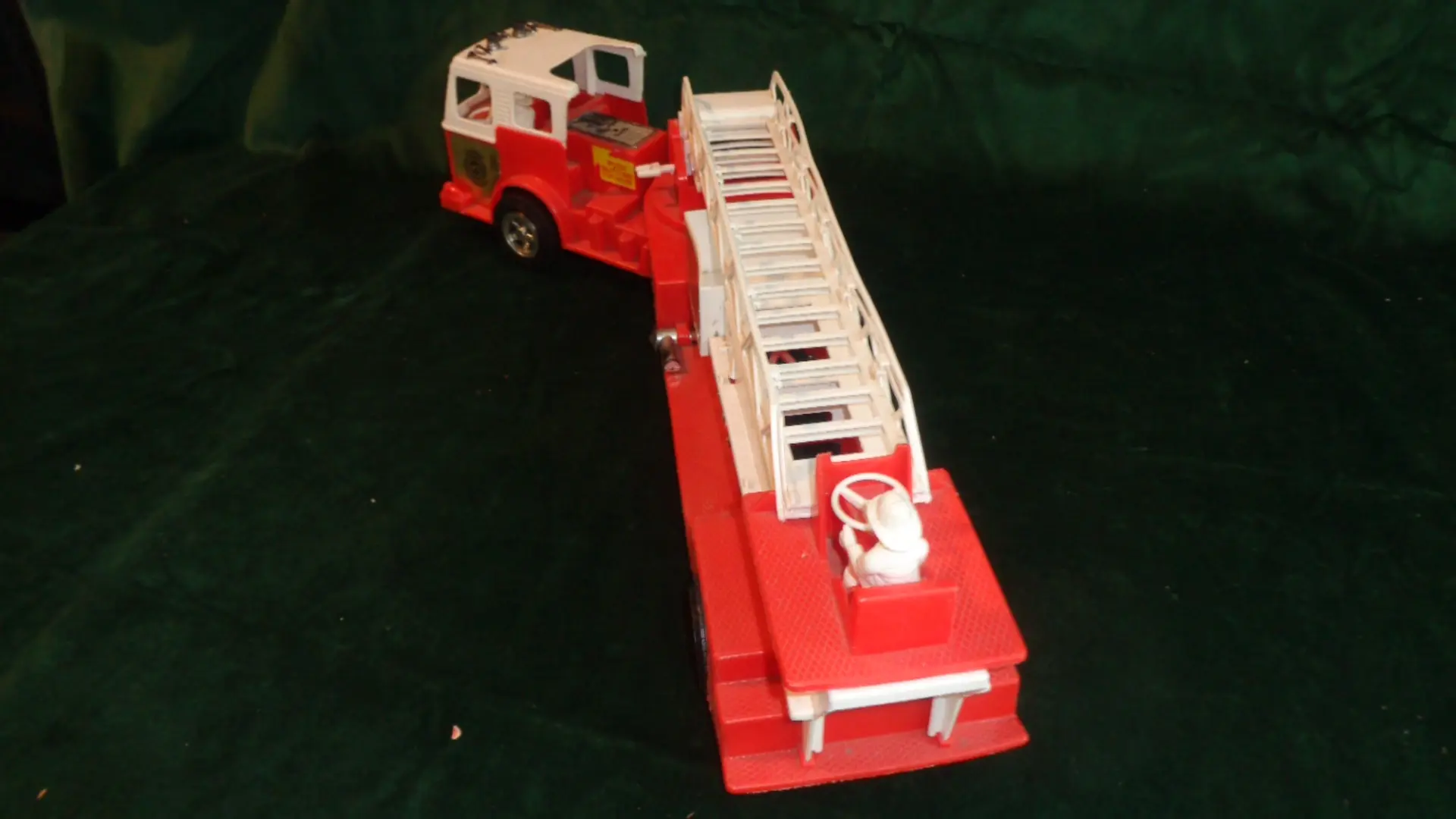 Vintage toy firetruck with hook and ladder