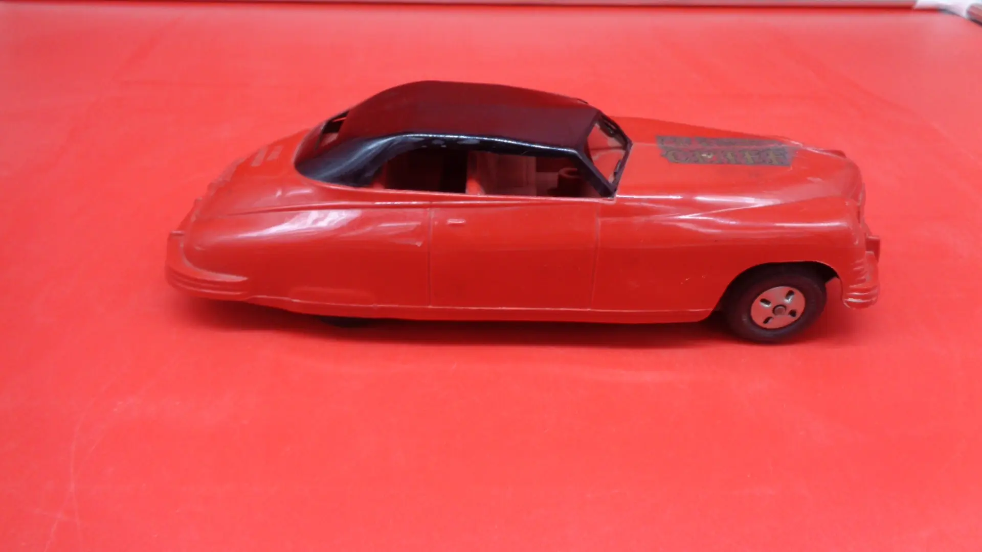 Display of Vintage Red car plastic toy