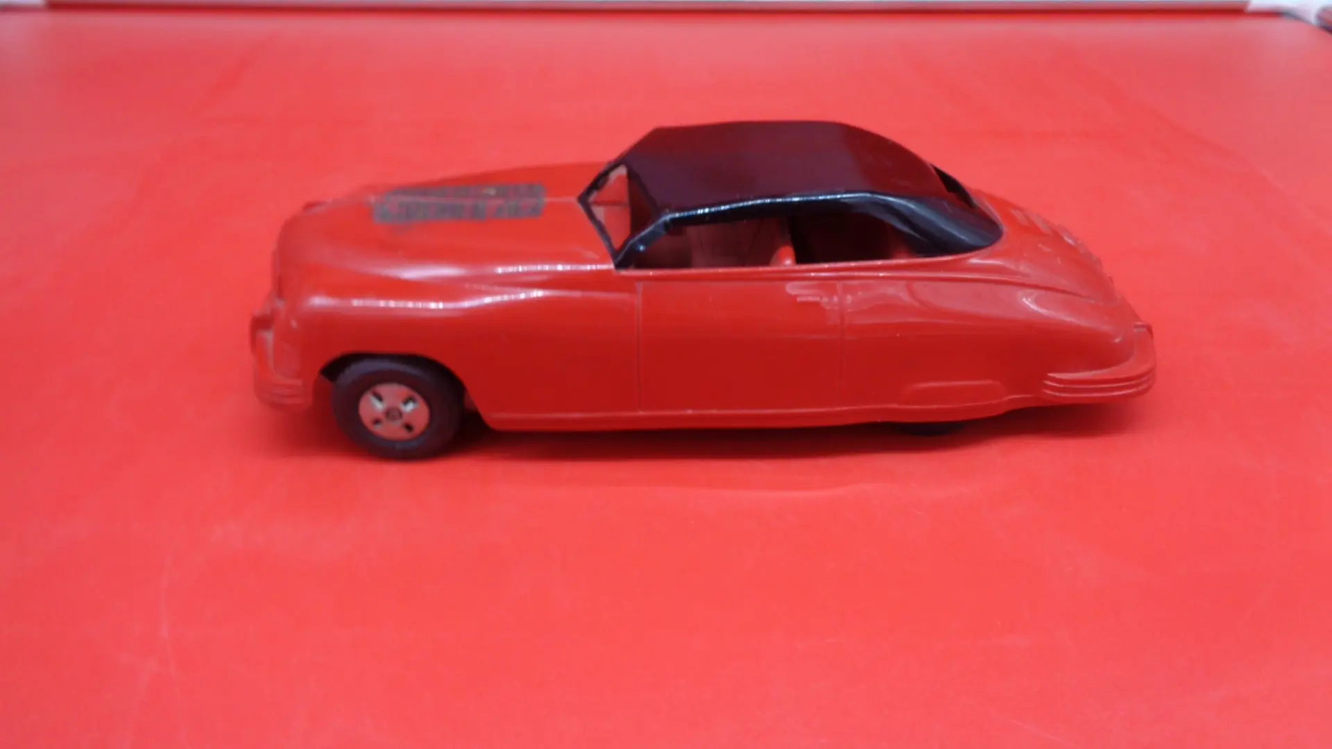 Vintage red color Fire Chief plastic toy car left side view