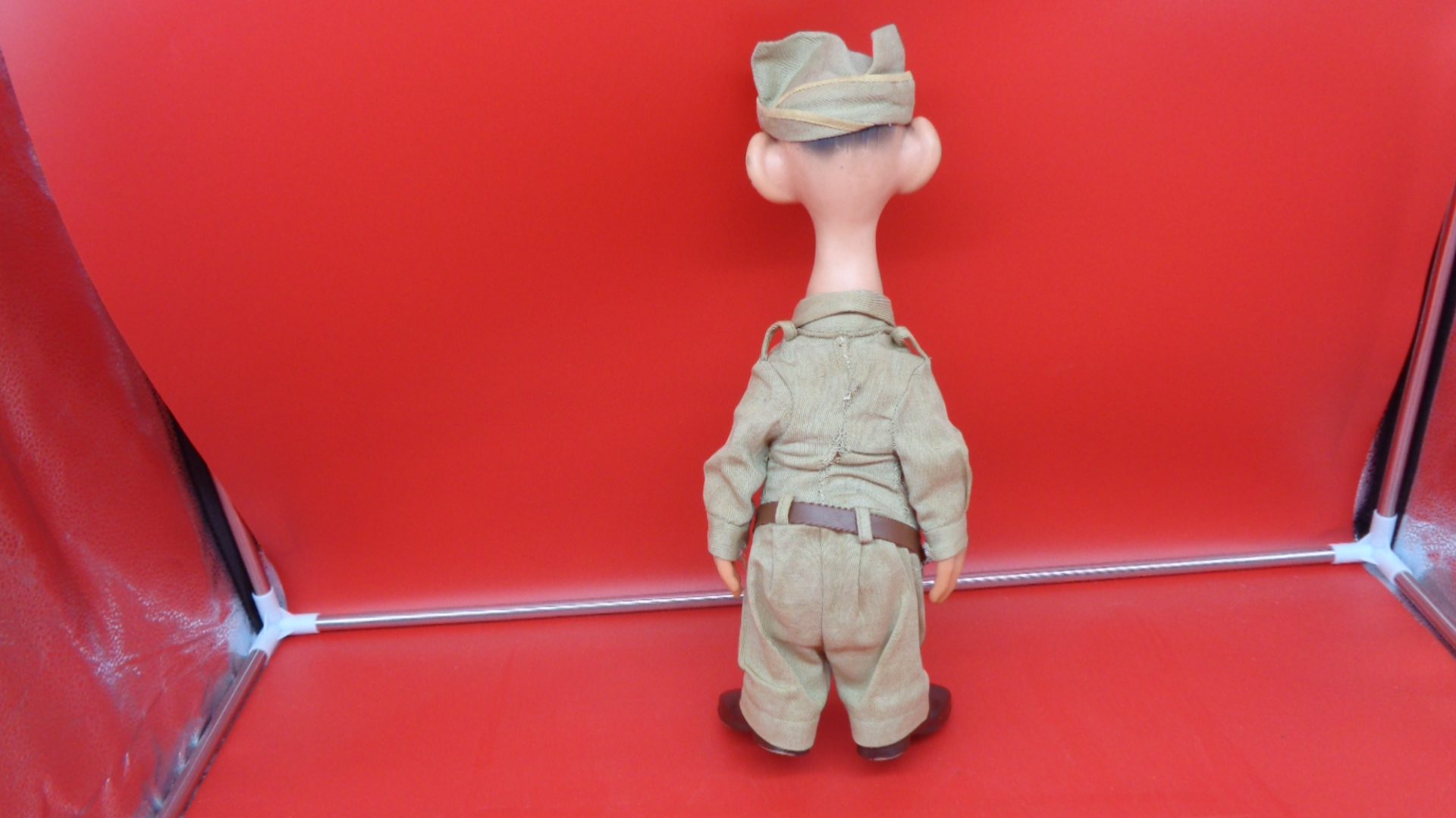 Display of rear view of US Military US Army Sad Sack Doll