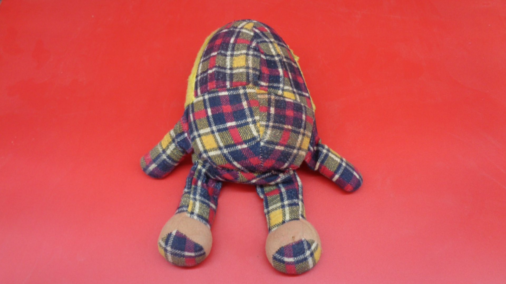 Display of rear view of Plush Humpty Dumpty Doll